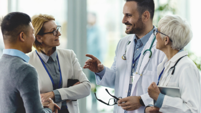 Healthcare team discussing common questions and solutions in a clinical environment for patient support and care.