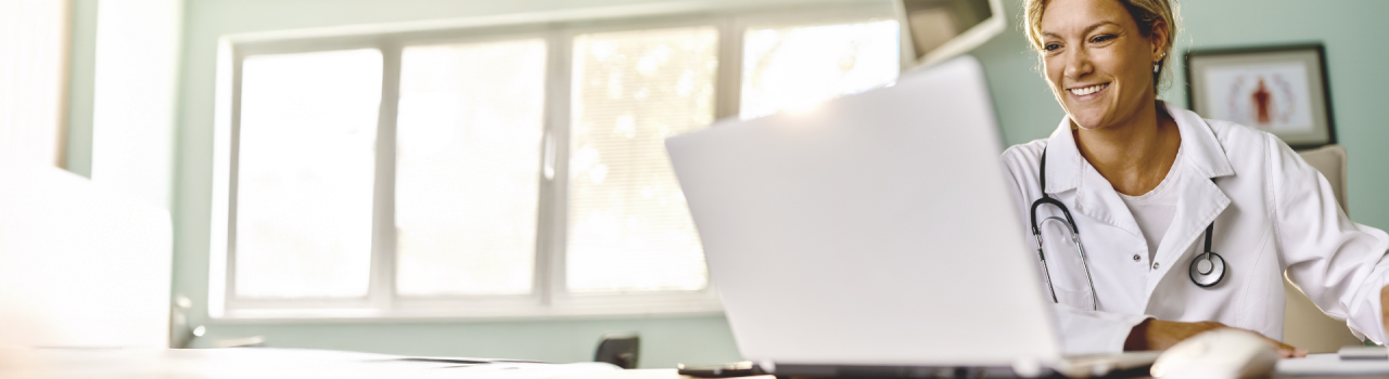 Smiling doctor in lab coat, highlighting resources that help patients make informed decisions about heart treatments.