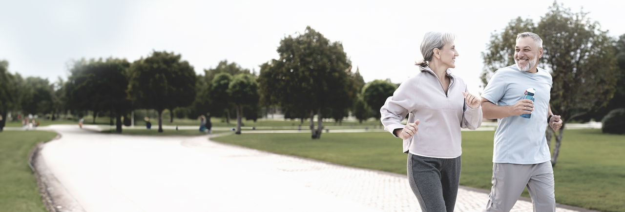Middle aged man and woman running,  promoting Boston Scientific treatment options